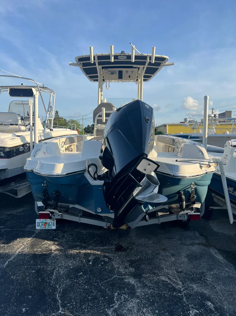Slide: The Image of 2020 Stingray 216 CC boat with outboard motor, docked in a marina. - 13