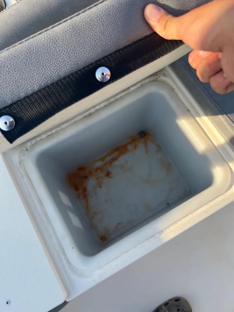 Slide: The Image of 2020 Stingray 216 CC boat storage compartment with lid open - 18