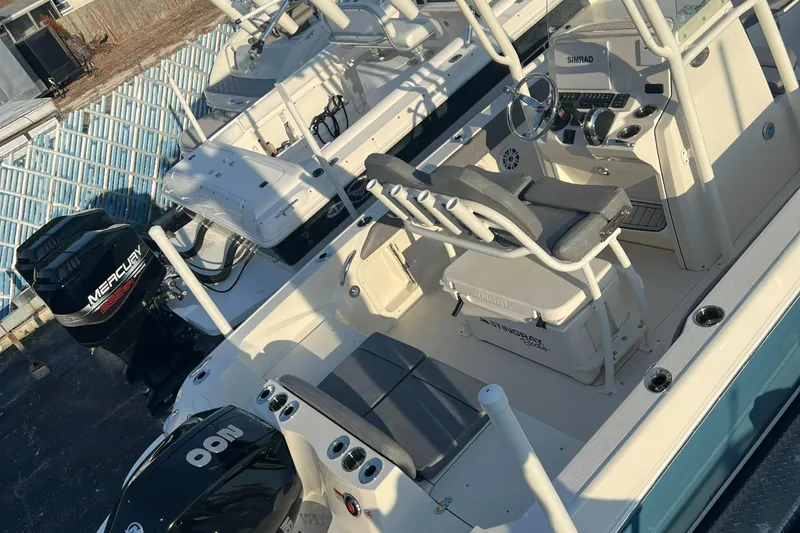Slide: The Image of 2020 Stingray 216 CC boat with dual Mercury outboard engines, white interior, and seating arrangement. - 20