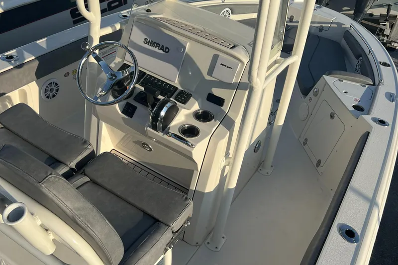 Slide: The Image of 2020 Stingray 216 CC boat interior with steering console and seating. - 22