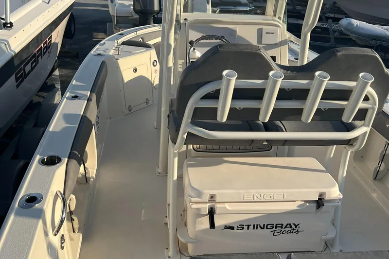 Slide: The Image of 2020 Stingray 216 CC boat interior with seating and storage. - 24