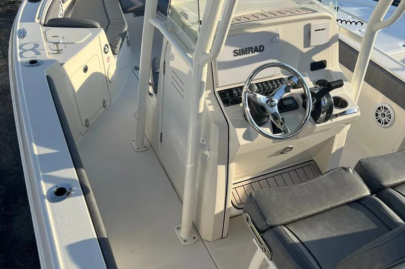 Slide: The Image of 2020 Stingray 216 CC boat interior with steering console and seating. - 25