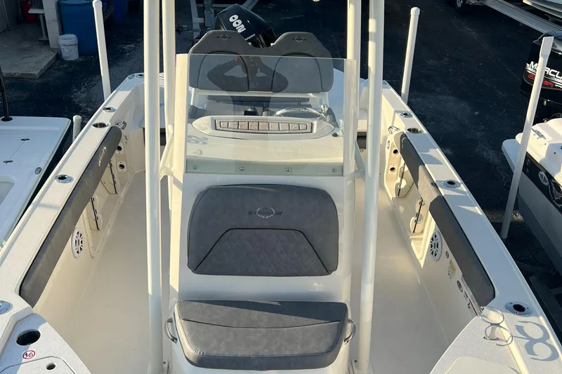 Slide: The Image of 2020 Stingray 216 CC center console boat interior with seating and controls. - 26