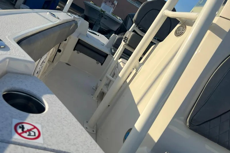 Slide: The Image of 2020 Stingray 216 CC boat interior with seating and storage compartments. - 27