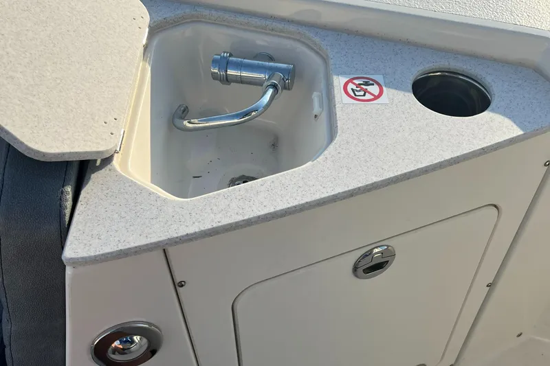 Slide: The Image of 2020 Stingray 216 CC boat sink and storage compartment. - 30