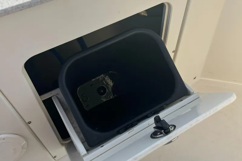 Slide: The Image of Open storage compartment on a 2020 Stingray 216 CC boat. - 31