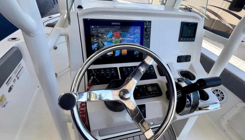 Slide: The Image of 2020 Stingray 216 CC boat dashboard with steering wheel and navigation system. - 34