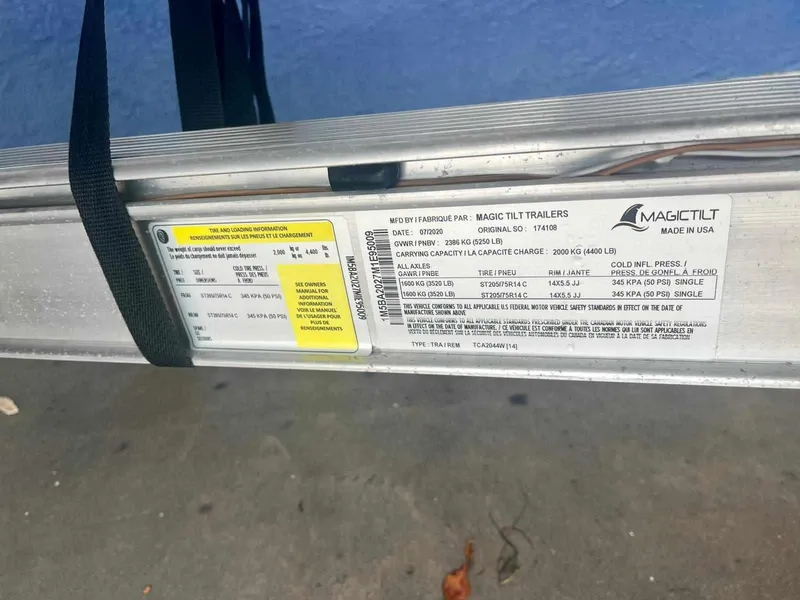 Slide: The Image of Magic Tilt trailer label for 2020 Stingray 216 CC boat, showing specifications and capacity. - 35