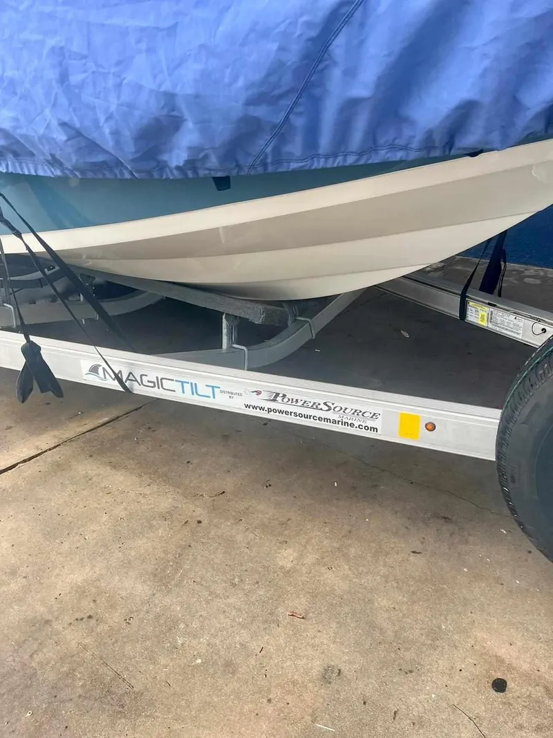 Slide: The Image of 2020 Stingray 216 CC boat on Magic Tilt trailer, partially covered. - 37
