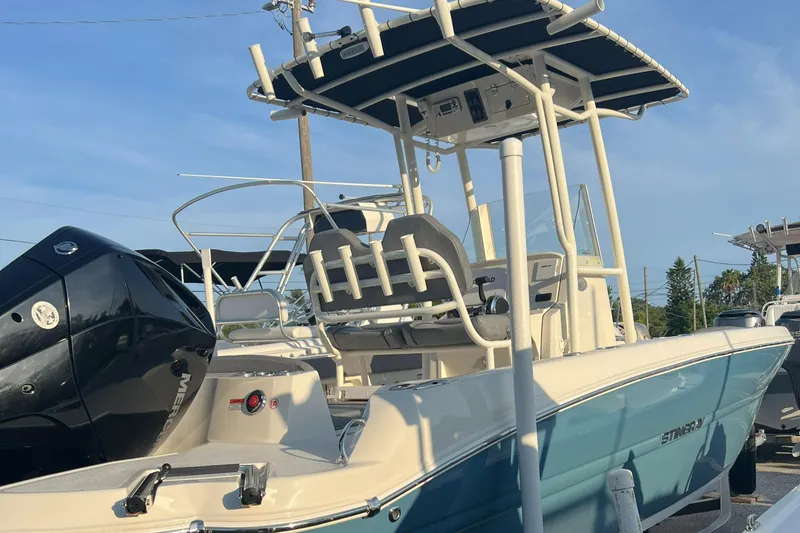 Slide: The Image of 2020 Stingray 216 CC boat with T-top and outboard motor. - 9