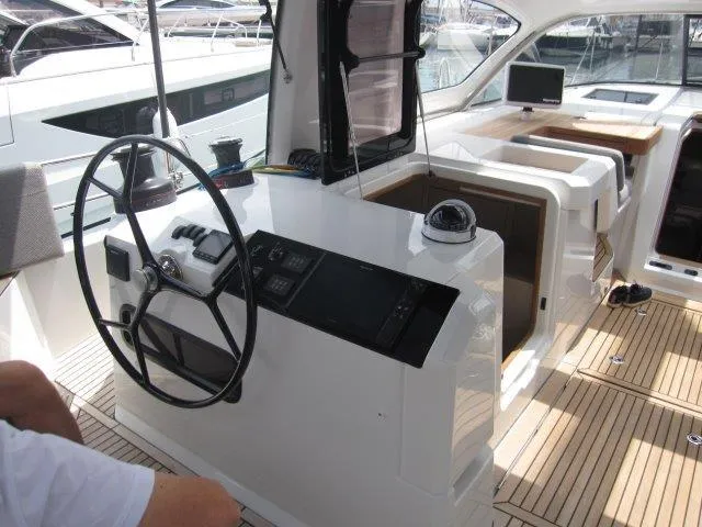 Slide: The Image of 2024 Jeanneau 55 yacht cockpit with modern navigation equipment and teak flooring. - 12