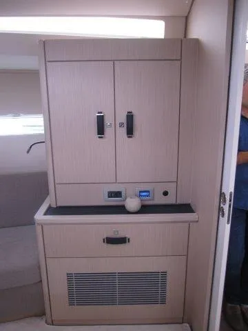 Slide: The Image of Interior of 2024 Jeanneau 55 yacht with modern cabinetry and seating area. - 18