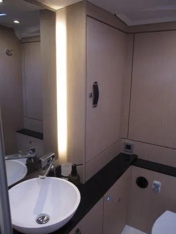 Slide: The Image of Modern bathroom in 2024 Jeanneau 55 yacht with sleek fixtures and ample storage. - 22