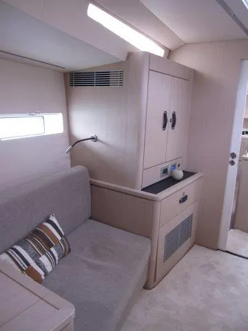 Slide: The Image of Modern interior of 2024 Jeanneau 55 yacht with cozy seating area. - 23