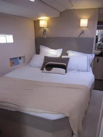 Slide: The Image of Luxurious bedroom in 2024 Jeanneau 55 yacht with modern lighting and cozy bedding. - 24