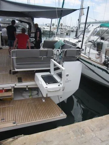 Slide: The Image of 2024 Jeanneau 55 yacht with spacious deck and modern amenities docked at marina. - 9