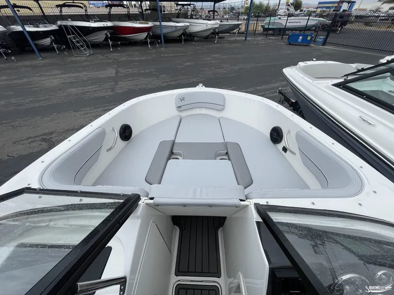 Slide: The Image of 2023 Bayliner VR4 boat interior with cushioned seating and sleek design. - 4