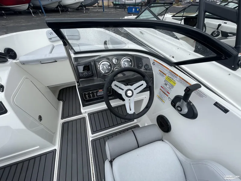 Slide: The Image of 2023 Bayliner VR4 boat cockpit with steering wheel and dashboard controls. - 6