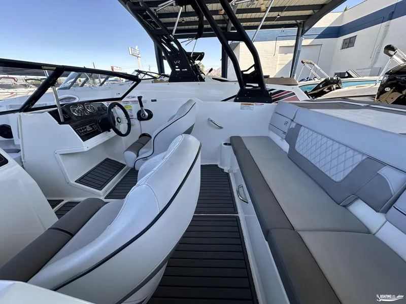 Slide: The Image of 2023 Bayliner VR4 boat interior with sleek seating and modern dashboard. - 9