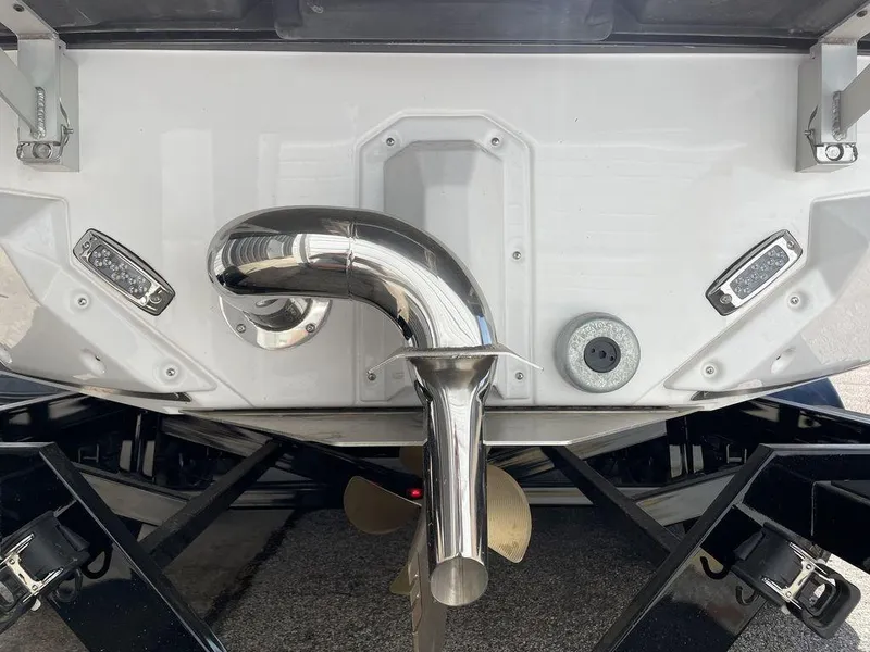 Slide: The Image of 2023 Nautique Super Air Nautique S25 boat exhaust and propeller detail. - 2