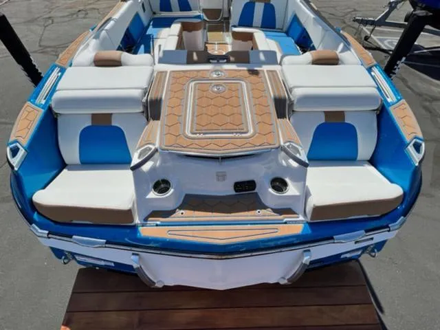 Slide: The Image of 2022 MasterCraft X26 boat with blue and white seating and teak accents. - 10