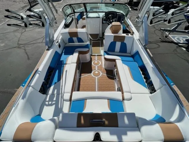 Slide: The Image of 2022 MasterCraft X26 boat interior with blue, white, and tan seating. - 11
