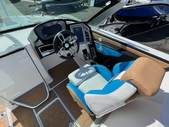Slide: The Image of 2022 MasterCraft X26 boat cockpit with modern steering wheel and touchscreen controls. - 12