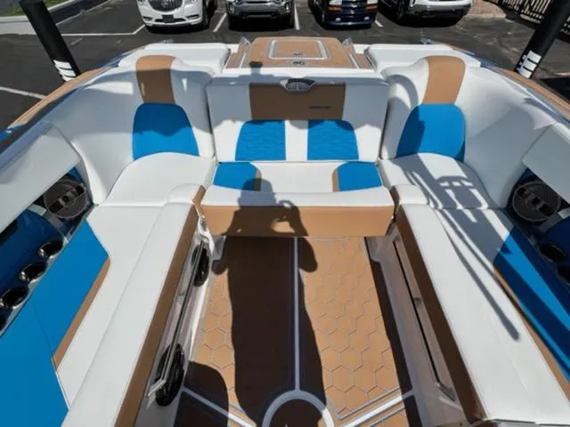 Slide: The Image of 2022 MasterCraft X26 boat interior with white, blue, and tan seating. - 15