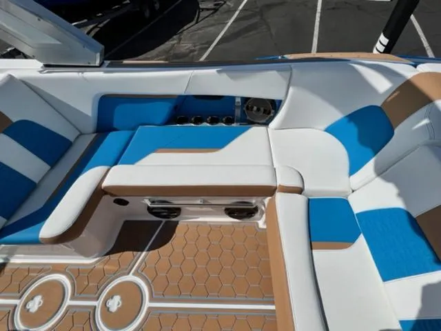 Slide: The Image of 2022 MasterCraft X26 boat interior with blue, white, and tan seating. - 16