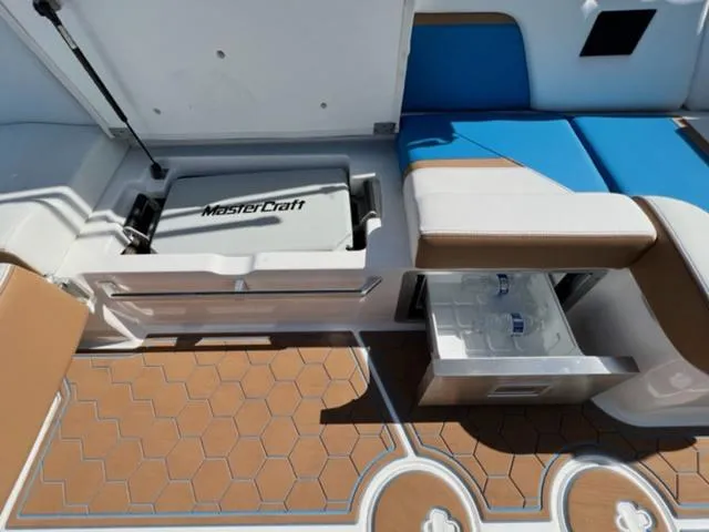 Slide: The Image of 2022 MasterCraft X26 boat interior with storage compartments and seating. - 17