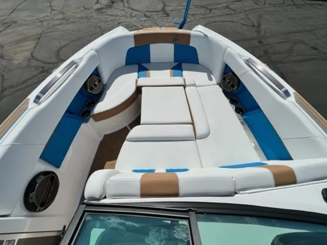 Slide: The Image of 2022 MasterCraft X26 boat interior with white, blue, and tan seating. - 18