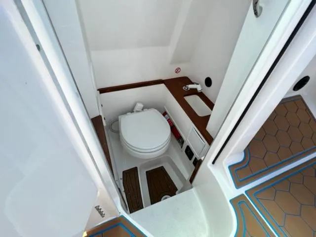 Slide: The Image of 2022 MasterCraft X26 boat interior bathroom with toilet and sink. - 21