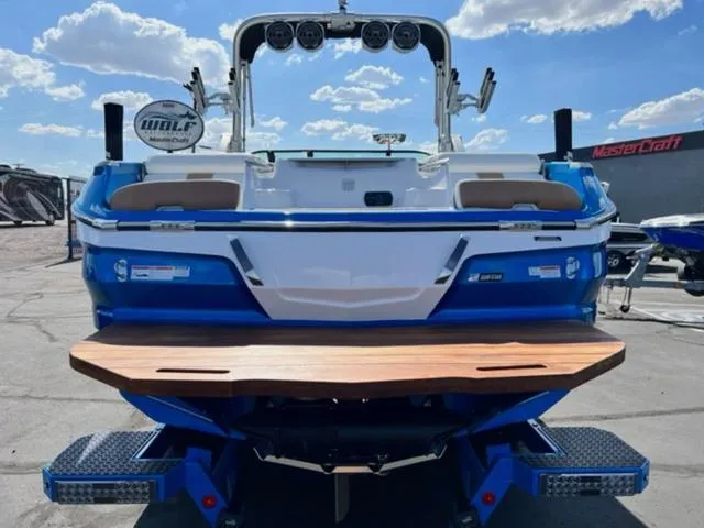 Slide: The Image of 2022 MasterCraft X26 boat rear view with swim platform and wakeboard tower. - 7