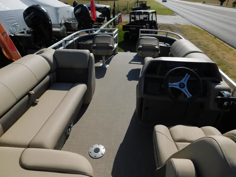 Slide: The Image of 2024 Sun Tracker Fishin' Barge 20 DLX pontoon boat interior with seating and steering console. - 11