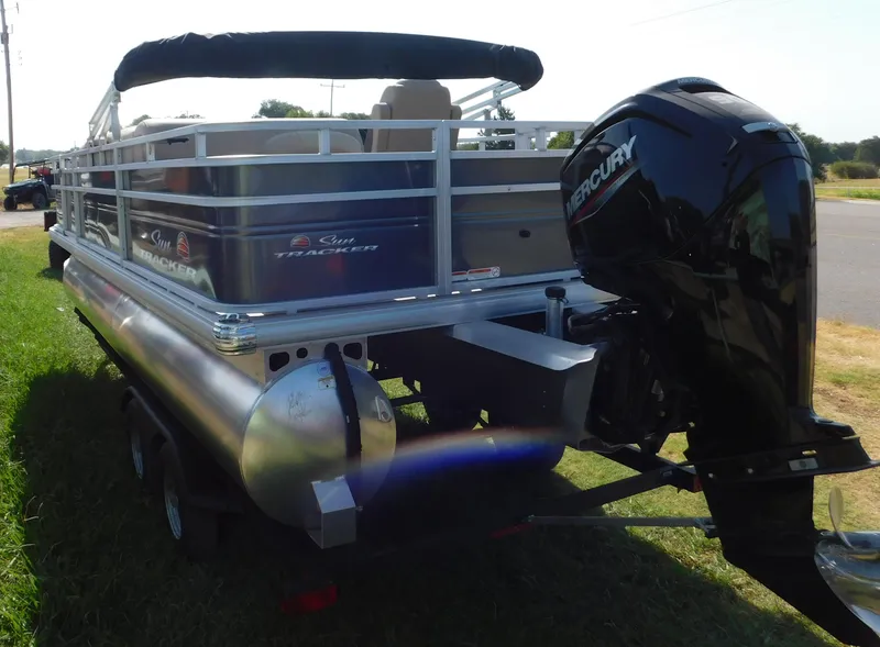 Slide: The Image of 2024 Sun Tracker Fishin' Barge 20 DLX pontoon boat with Mercury outboard motor. - 2