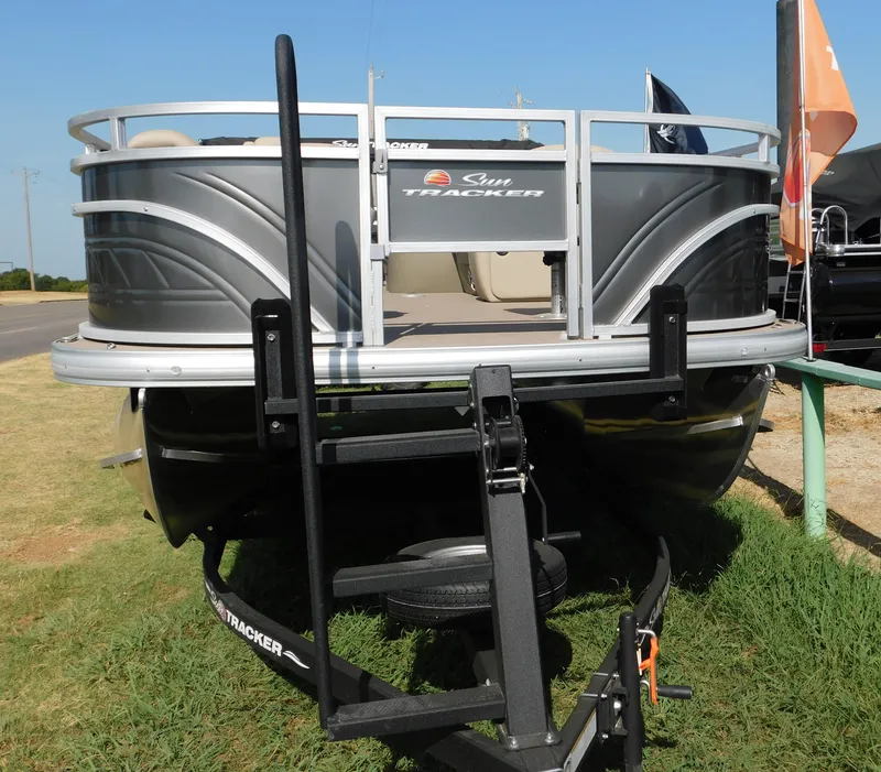 Slide: The Image of 2024 Sun Tracker Fishin' Barge 20 DLX pontoon boat on trailer. - 6