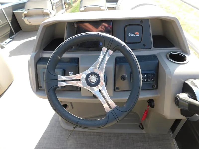 Slide: The Image of 2024 Sun Tracker Fishin' Barge 20 DLX steering console with modern controls. - 7
