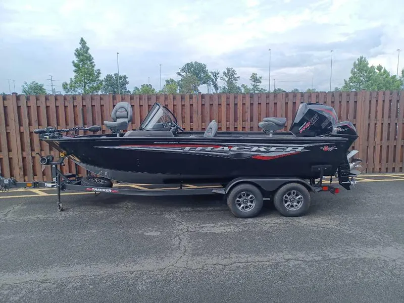 The Image of 2024 Tracker Targa V-19 Combo boat on a trailer in a parking lot. - 0