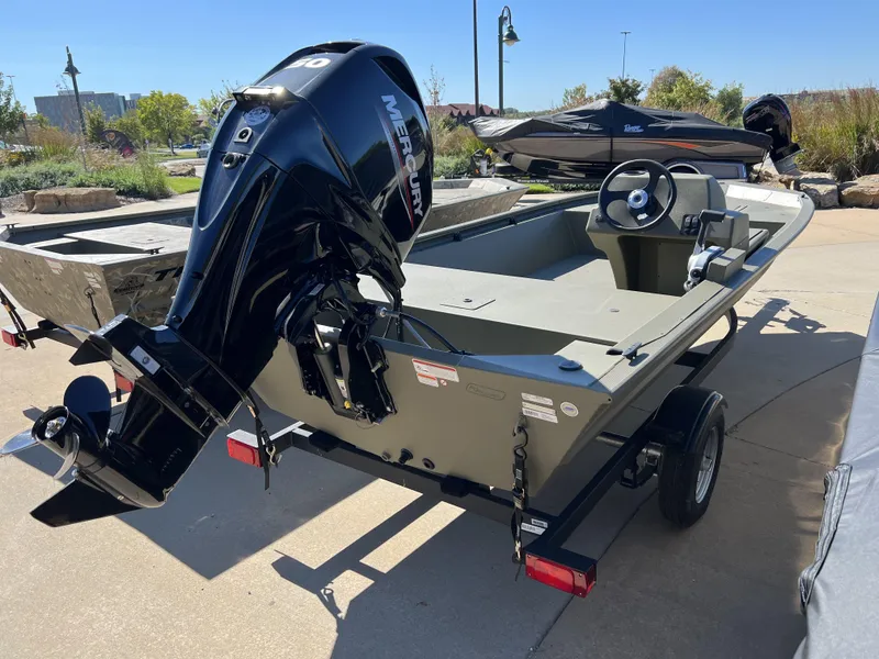 Slide: The Image of 2024 Tracker Grizzly 1648 SC boat with Mercury outboard motor on trailer. - 3