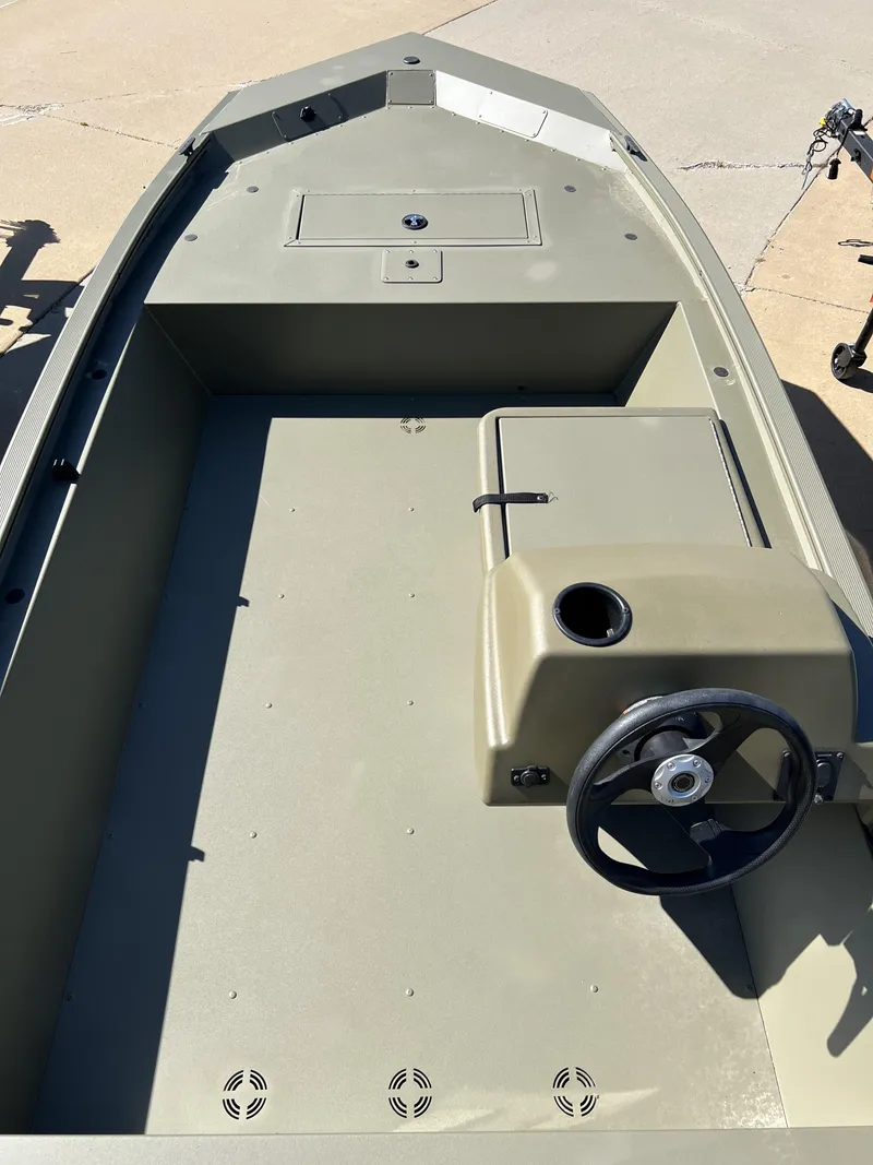 Slide: The Image of 2024 Tracker Grizzly 1648 SC boat interior with steering console. - 6