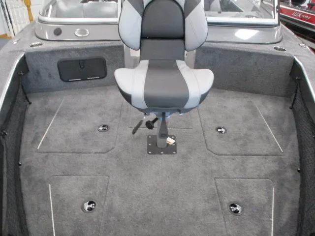 Slide: The Image of 2024 MirroCraft 1963 Aggressor boat interior with gray carpet and swivel seat. - 2