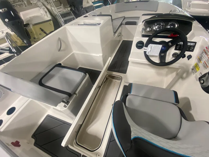 Slide: The Image of 2024 Bayliner Element M19 boat interior with steering wheel and seating. - 15