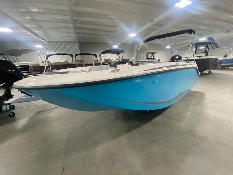 Slide: The Image of 2024 Bayliner Element M19 boat in showroom, blue hull, black canopy. - 3