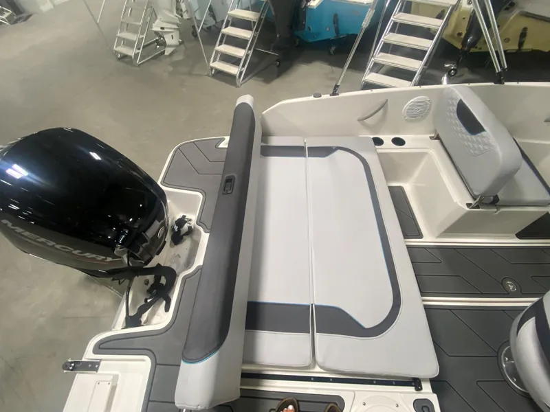 Slide: The Image of 2024 Bayliner Element M19 boat interior with seating and outboard motor. - 7