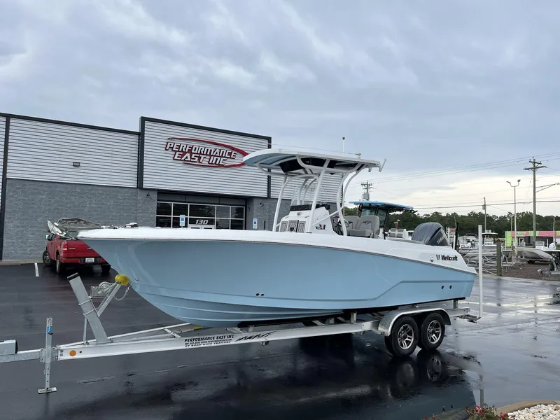 The Image of 2023 Wellcraft 242 Fisherman boat on a trailer outside Performance East Inc. dealership. - 1
