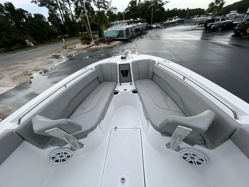 Slide: The Image of 2023 Wellcraft 242 Fisherman boat interior with gray seating and white deck. - 9