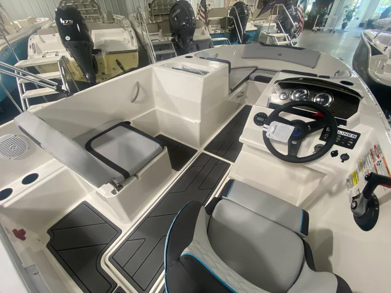 Slide: The Image of 2024 Bayliner Element M19 boat interior with steering console and seating. - 12