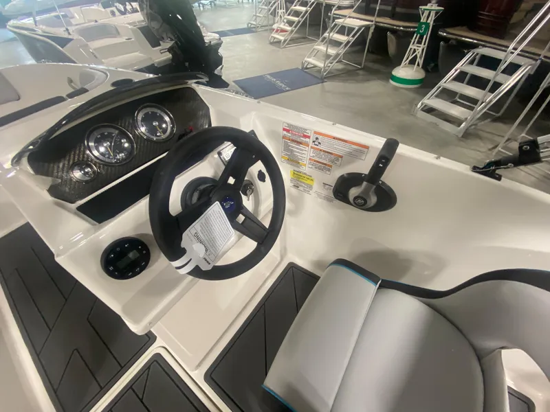 Slide: The Image of 2024 Bayliner Element M19 boat cockpit with steering wheel and control panel. - 14