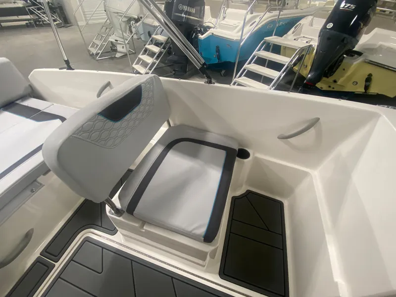 Slide: The Image of 2024 Bayliner Element M19 boat interior with seating and storage compartments. - 18
