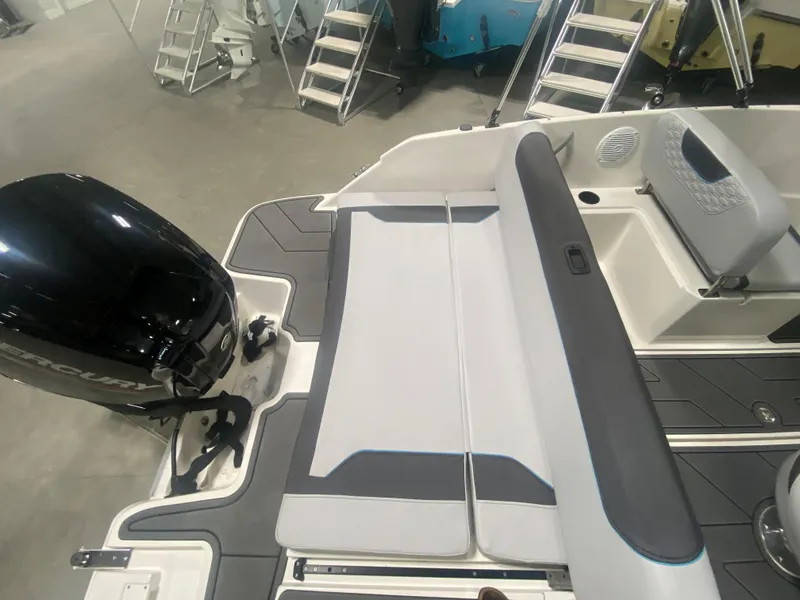 Slide: The Image of 2024 Bayliner Element M19 boat interior with seating and outboard motor. - 8